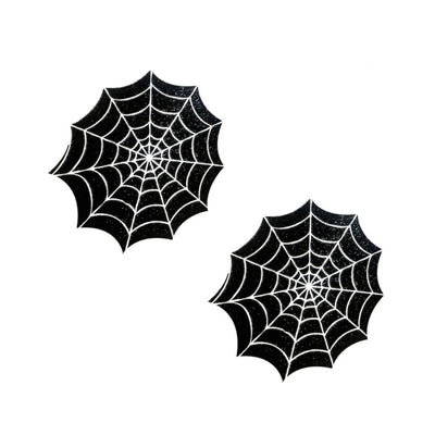 Pair of black spider web design pasties with white detailing on a white background