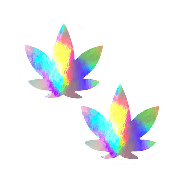 Pair of holographic weed leaf-shaped nipple covers with a rainbow iridescent finish on white background.