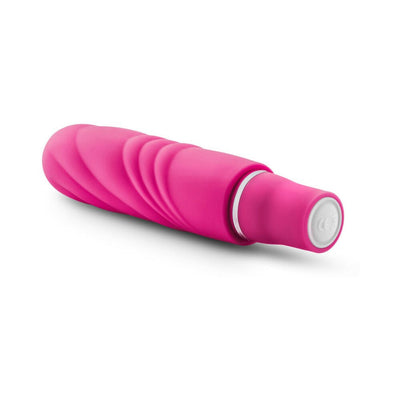 Pink silicone mini stimulator with textured swirl design and white control button on a white background.