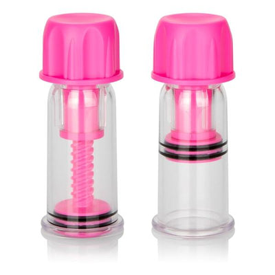 Pair of clear nipple vacuum suckers with bright pink twist caps and adjustable pressure mechanisms.