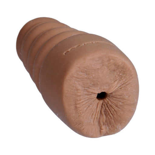 Caramel-colored compact male masturbator sleeve made from soft, realistic UR3 material with textured exterior.