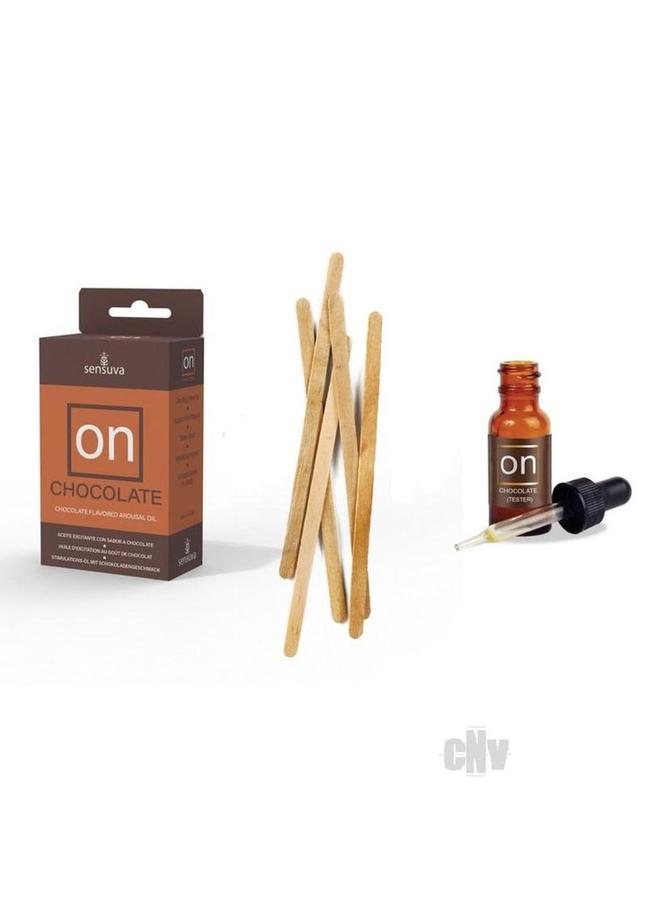 On Chocolate arousal oil box with 5ml amber dropper bottle and wooden applicator sticks on white background.