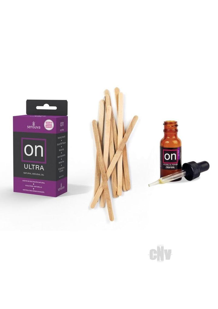 On Ultra natural arousal oil box with tester bottle, dropper, and wooden applicator sticks on white background.