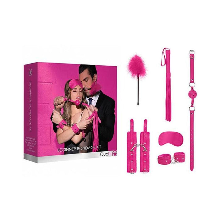 Pink beginners bondage kit with hand and leg cuffs, ball gag, flogger, feather tickler, and satin eye mask with packaging box.