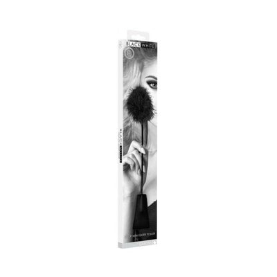 Black and white boxed feather tickler crop with bonded leather handle shown with model on packaging.