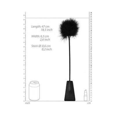 Black and white feather tickler crop with bonded leather handle shown with size measurements and comparison to a soda can and lipstick.