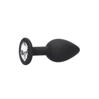 Black silicone butt plug with a tapered shape and removable clear jewel at the flared base.