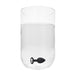 Black and white silicone butt plug with a removable clear jewel base submerged in a clear glass of water.