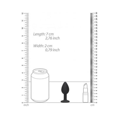 Black and white silicone butt plug with removable jewel shown next to a soda can and lipstick for size comparison.