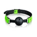 Adjustable breathable ball gag with black ball and neon green glow-in-the-dark PU leather strap.