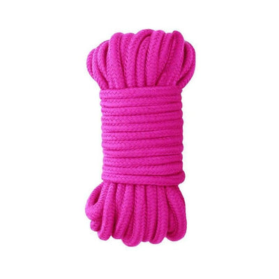 Bright pink silky Japanese rope neatly coiled for versatile and comfortable rope play sessions.