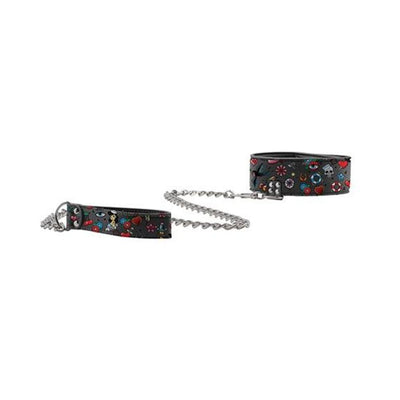Black bonded leather collar and leash set with colorful old school tattoo prints and metal chain detail.