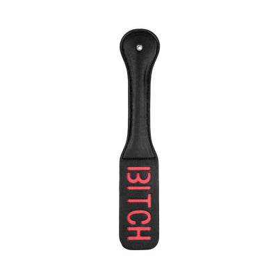 Black leather paddle with stitched edges and reversed red "BITCH" lettering on the striking surface.