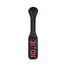 Black leather paddle with stitched edges and reversed red "BITCH" lettering on the striking surface.