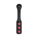 Black leather paddle with three red heart cutouts and stitched detailing, designed for playful impact.