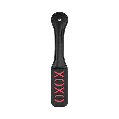 Black leather paddle with stitched handle and reversed red "XOXO" cutout design on the striking paddle face.