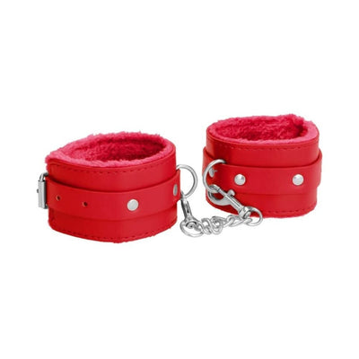 Red plush-lined leather wrist cuffs with adjustable straps and metal chain connector on white background.