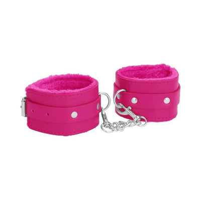 Pair of bright pink plush-lined leather wrist cuffs connected by a silver chain and clasp for adjustable restraint.