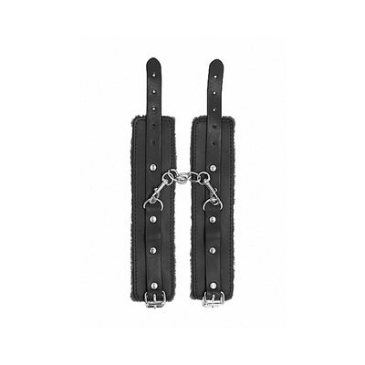 Black plush-lined leather wrist cuffs with adjustable straps and metal chain connectors for secure fetish play.