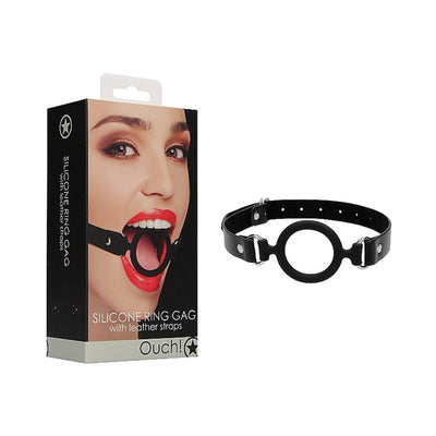 Black silicone ring gag with adjustable leather straps displayed next to its packaging featuring a model wearing the gag.