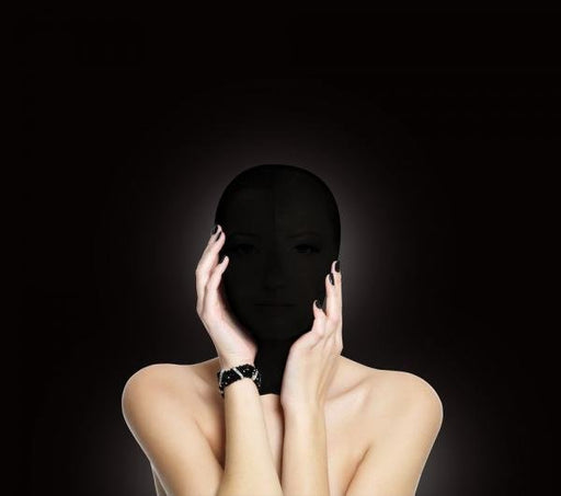 Person wearing a black stretchy subjugation mask covering the entire head with hands gently touching the face.