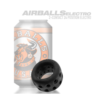 Black silicone ballstretcher with multiple ventilation holes displayed in front of branded can packaging.