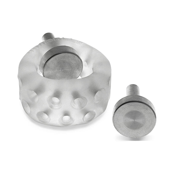 Clear silicone ballstretcher with multiple holes and two metal electro contact plugs displayed on white background.