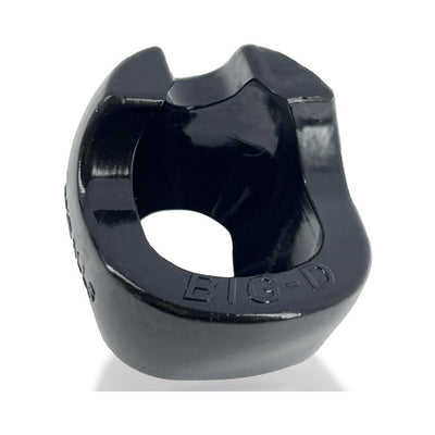 Black glossy oval-shaped Oxballs Big-D shaft grip cockring with raised edges and embossed branding on front.