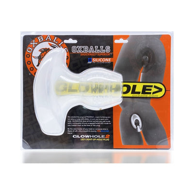 Oxballs Glowhole-1 small clear frosted LED light-up silicone buttplug in retail packaging with product details and branding.