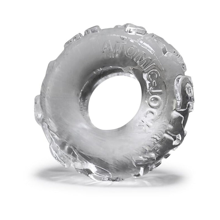 Clear textured circular cockring made of flexible jelly material with embossed branding detail.