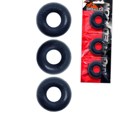 Three black Atomic-Jock cockrings displayed next to their red and black Oxballs Night Edition packaging.