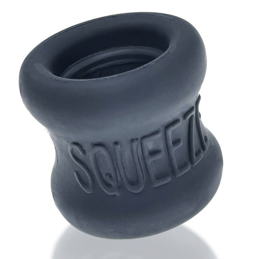 Black silicone hourglass-shaped ballstretcher with embossed SQUEEZE logo and smooth matte finish.