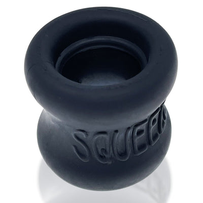 Black silicone hourglass-shaped ballstretcher with embossed "SQUEEZE" branding on the side.