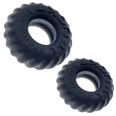 Two black silicone cockrings designed like rugged truck tires with embossed "TRUCKT" branding on a white background.