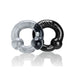 Two Oxballs Ultraballs cockrings in black and clear, made from flexible stretch material with embossed branding.