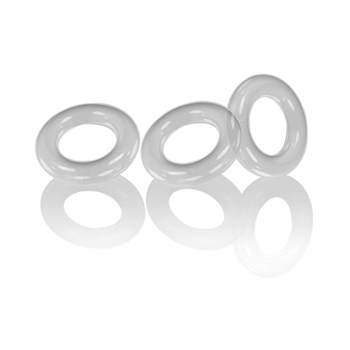 Three clear, flexible cockrings displayed on a reflective white surface.