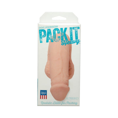 Pack It Heavy realistic dildo packer in flesh tone displayed in clear retail packaging with blue text and American flag icon.