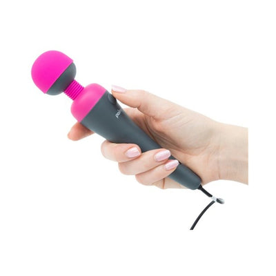 Hand holding a grey and fuchsia Palm Power Plug & Play USB-powered massager with attached charging cable.