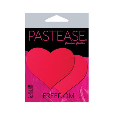 Pastease neon red heart-shaped nipple pasties in black light reactive packaging, latex-free and made in the USA.