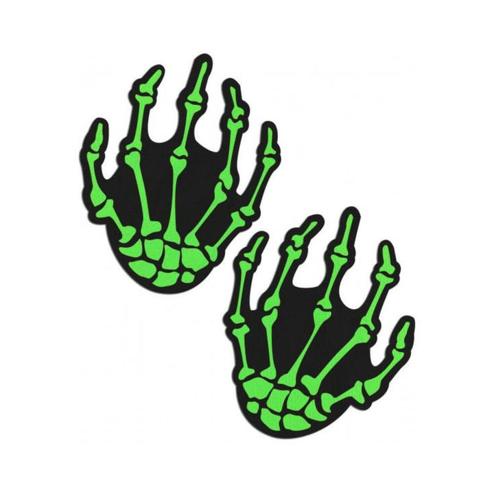 Pair of neon green skeleton hand-shaped nipple pasties with black background by Pastease
