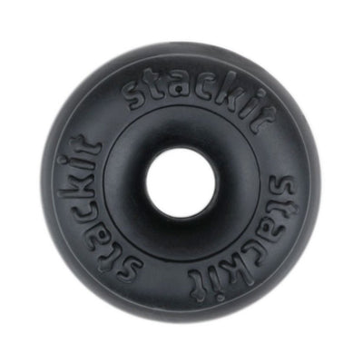 Black circular Stackit cock ring made of soft material with the brand name embossed around the center hole.