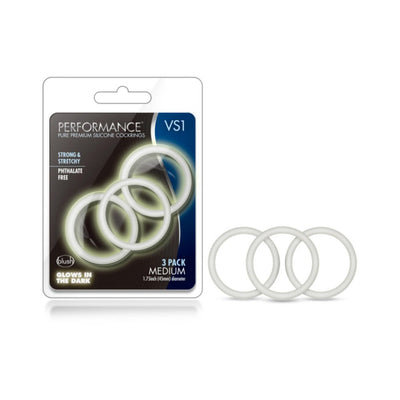 Performance VS1 medium silicone cock rings 3-pack with glow-in-the-dark feature in clear packaging and three white rings displayed.
