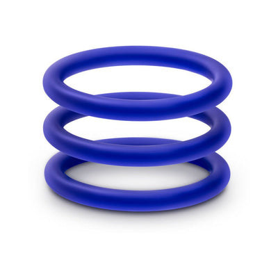 Set of three medium-sized blue silicone rings stacked on a white background for male enhancement.