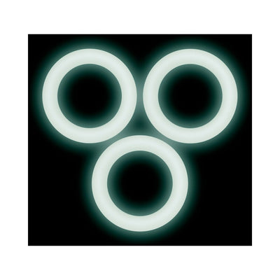 Three glowing white silicone rings arranged on a black background, highlighting their smooth, flexible design.