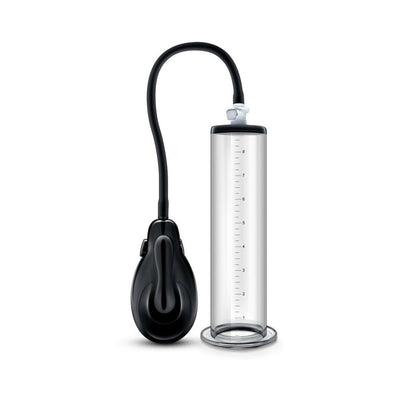 Clear cylinder penis pump with black manual hand pump and flexible tubing on white background.