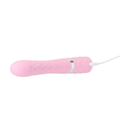 Pink silicone dual stimulator with textured handle and USB charging cable attached on white background