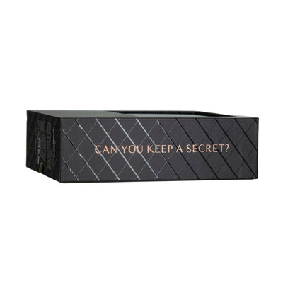 Black rectangular product box with a diamond pattern and the phrase "CAN YOU KEEP A SECRET?" in rose gold lettering on the side.