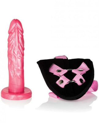 Pink 7.5 inch realistic dildo with black and pink adjustable velvet harness straps on white background.