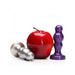 Silver 3 Scoops plug next to a red apple and a purple textured plug on a white background.