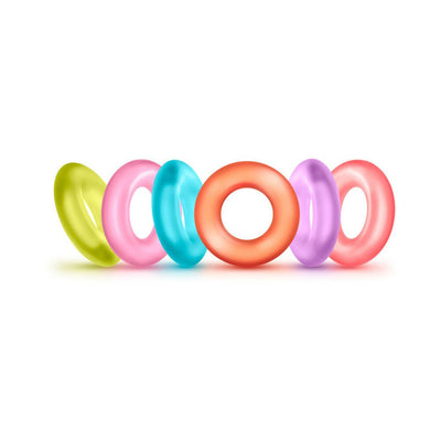 Set of six colorful translucent rings in green, pink, blue, orange, purple, and red arranged in a row on a white background.